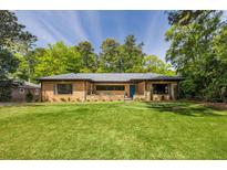Charming brick home with a well-manicured lawn and mature trees offering great curb appeal at 639 W Ponce De Leon Ave, Decatur, GA 30030