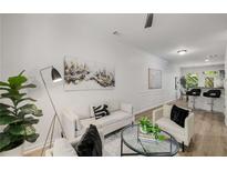 Bright living room with light colored hardwood floors, modern furnishings, and decorative art at 863 Commonwealth Se Ave, Atlanta, GA 30312