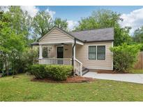 Charming single-story home with a welcoming front porch and well-maintained lawn at 2864 White Oak Dr, Decatur, GA 30032