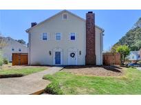 Charming two-story townhome with a well-maintained lawn and inviting curb appeal at 5554 Clover Rise Ln, Norcross, GA 30093