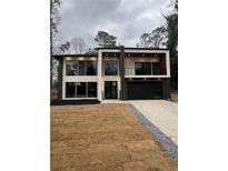 Modern two-story home featuring a balcony and large windows at 1921 Herbert Dr, Tucker, GA 30084