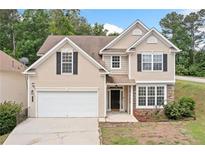 Charming two-story home with neutral siding, black shutters, and a two-car garage at 4405 Feather Way, Douglasville, GA 30135