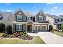 Charming two-story home with a well-manicured lawn and a two-car garage, creating a welcoming curb appeal at 3883 Wakefield Hall Se Sq, Smyrna, GA 30080