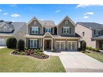 Charming two-story home with a manicured lawn and a two-car garage at 3883 Wakefield Hall Se Sq, Smyrna, GA 30080
