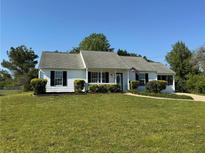Charming single-story home with manicured lawn, trimmed shrubbery, and a welcoming front entrance at 472 Linda Ln, Powder Springs, GA 30127