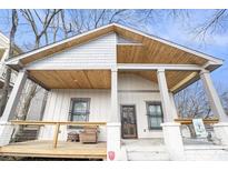 Charming bungalow showcasing a welcoming front porch with exposed rafter tails and a cozy seating area at 953 Michigan Ave, Atlanta, GA 30314