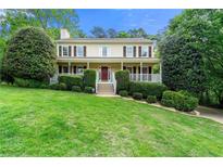 Inviting two-story home with a covered porch, manicured lawn, and well-maintained landscaping at 706 Briarleigh Sw Ct, Mableton, GA 30126