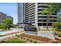 Luxury condo building, Park Place on Peachtree, with manicured lawn and colorful flowers at 2660 Peachtree Nw Rd # 4G, Atlanta, GA 30305