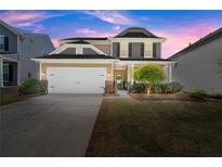 Inviting two-story home featuring a manicured lawn and a convenient two-car garage at 357 Ridgewood Trl, Canton, GA 30115