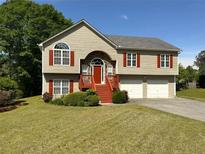 Charming two-story home with a well-maintained lawn, red shutters, and a two car garage at 4003 Preston Place Ln, Powder Springs, GA 30127