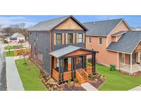 Beautiful two-story home with a inviting front porch, wood accents and well-maintained lawn at 701 Smith St, Atlanta, GA 30310