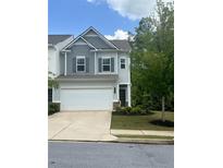Charming two-story home featuring a two-car garage, neat landscaping, and classic architectural details at 235 Centennial Cir, Canton, GA 30114