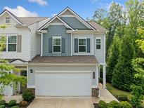Charming two-story home with two-car garage, well-maintained lawn and professionally landscaped yard at 235 Centennial Cir, Canton, GA 30114