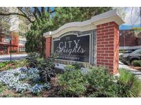City Heights Condominiums sign with manicured landscaping and colorful flowers in front of the building at 375 Ralph Mcgill Blvd # 1503, Atlanta, GA 30312