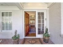 Elegant front door with sidelight, transom, and brickwork entryway leads into a bright, inviting home at 1299 W Wesley Nw Rd, Atlanta, GA 30327