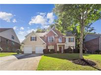 Charming two-story home with a well-manicured lawn, two-car garage, and beautiful landscaping at 1520 Ethans Way, Mcdonough, GA 30252