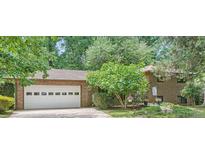 Charming brick home with a well-manicured front yard and attached two-car garage at 2687 Goodfellows Rd, Tucker, GA 30084