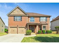 Charming two-story red brick home with a well-manicured lawn and a two-car garage, perfect for Gathering living at 532 Pelham Pl, Mcdonough, GA 30253