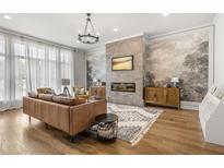Bright living room with decorative fireplace and hardwood floors at 613 Harrington Hls, Decatur, GA 30032