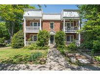Charming brick townhouse featuring double balconies and lush landscaping at 974 Greenwood Ne Ave # 6, Atlanta, GA 30306