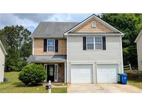 Charming two-story home with a two-car garage and well-manicured lawn, creating a welcoming curb appeal at 3104 Leyland Ct, Decatur, GA 30034