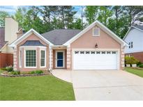 Charming one-story home featuring a manicured lawn, bay window, and a two-car garage at 4535 Clipper Bay Rd, Duluth, GA 30096