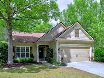 Charming one-story home with well-maintained lawn, inviting curb appeal and attached two-car garage at 111 Churchcliff Dr, Woodstock, GA 30188