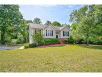 Charming home with a manicured lawn and mature trees in a suburban setting at 4199 Wyndham Park Way, Buford, GA 30519