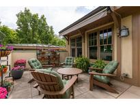Inviting outdoor patio area with comfortable seating and lush potted flowers, perfect for relaxation at 1868 Gordon Ne Mnr, Atlanta, GA 30307