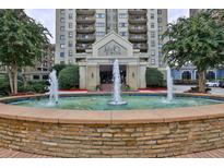 Attractive high-rise building featuring a water fountain and well-maintained landscaping at the entrance at 795 Hammond Dr # 808, Atlanta, GA 30328
