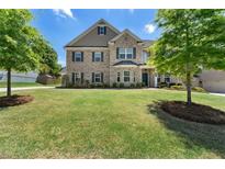 Charming two-story brick home boasts a well-manicured lawn and mature trees in a desirable neighborhood at 3051 Mountain Shadow Way, Marietta, GA 30064