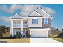 Charming two-story home with a welcoming double porch, a beautiful stone facade, and an attached two-car garage at 4120 Chapel Hill Reserve, Douglasville, GA 30135