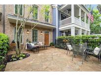 Charming stone patio with outdoor seating, perfect for entertaining or relaxing at 719 Hammond Dr, Woodstock, GA 30188