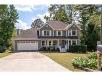 Charming two-story home with a welcoming front porch and well-maintained landscaping at 737 Dushea Nw Ct, Kennesaw, GA 30144