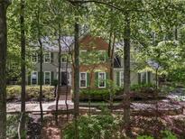 Charming two-story home with brick and siding, green shutters and lush landscaping at 1819 Walker Ridge Sw Dr, Marietta, GA 30064