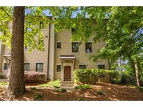 Exterior of multi-story townhouse with brick facade, well-maintained landscaping, and a covered front entrance at 217 Knob Hills Cir, Decatur, GA 30030