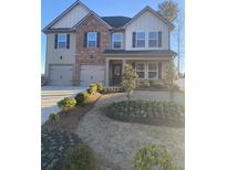 Charming two-story home with a well-manicured lawn and a welcoming entrance at 733 Great Oak Pl, Villa Rica, GA 30180