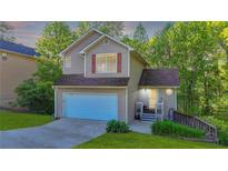 Charming two-story home with a well-manicured lawn, attached garage, and inviting front porch at 986 Franklin Ridge Ct, Sugar Hill, GA 30518