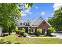 Charming brick two-story home with a landscaped front yard and welcoming curb appeal at 1156 Cotton Gin Ct, Lawrenceville, GA 30045