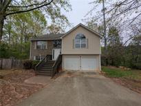 Charming two-story home featuring a two-car garage, brick accents, and a welcoming front porch at 3413 Creekview Dr, Rex, GA 30273