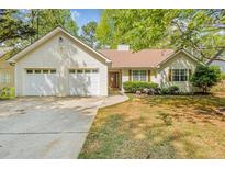 Charming single-Gathering home featuring a two-car garage and well-maintained front yard landscaping at 6095 Wayfarer Dr, Villa Rica, GA 30180