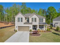 Stunning two-story home with a brick facade, complemented by a manicured lawn and a cozy covered front porch at 5003 Fairview Cir, Villa Rica, GA 30180