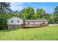 Charming home with a large front yard and inviting deck area, perfect for outdoor relaxation at 6450 Ivey Se Rd, Mableton, GA 30126