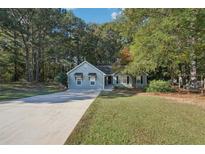 Charming home with a long drive, well manicured lawn, and inviting exterior at 45 Park Place Dr, Covington, GA 30016