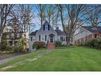 Charming home with a well-manicured lawn and mature trees surrounding the property at 491 Princeton Ne Way, Atlanta, GA 30307