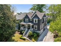 Charming two-story home with a well-manicured lawn, stone accents, and a private driveway at 331 Peachtree Ne Ave, Atlanta, GA 30305