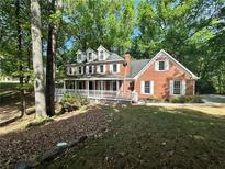 Charming two-story brick home with a welcoming front porch and white trim at 894 Oak Rd, Lawrenceville, GA 30044