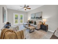 Bright living room with a ceiling fan and glass doors that lead to a balcony at 821 Ralph Mcgill Ne Blvd # 3325, Atlanta, GA 30306