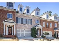 Charming brick townhomes with well-manicured landscaping and inviting front entrances on a sunny day at 10462 Bent Tree Vw, Duluth, GA 30097