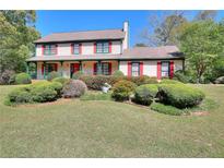 Charming two-story home with a lush front yard and inviting front porch at 3740 Laurel Brook Way, Snellville, GA 30039